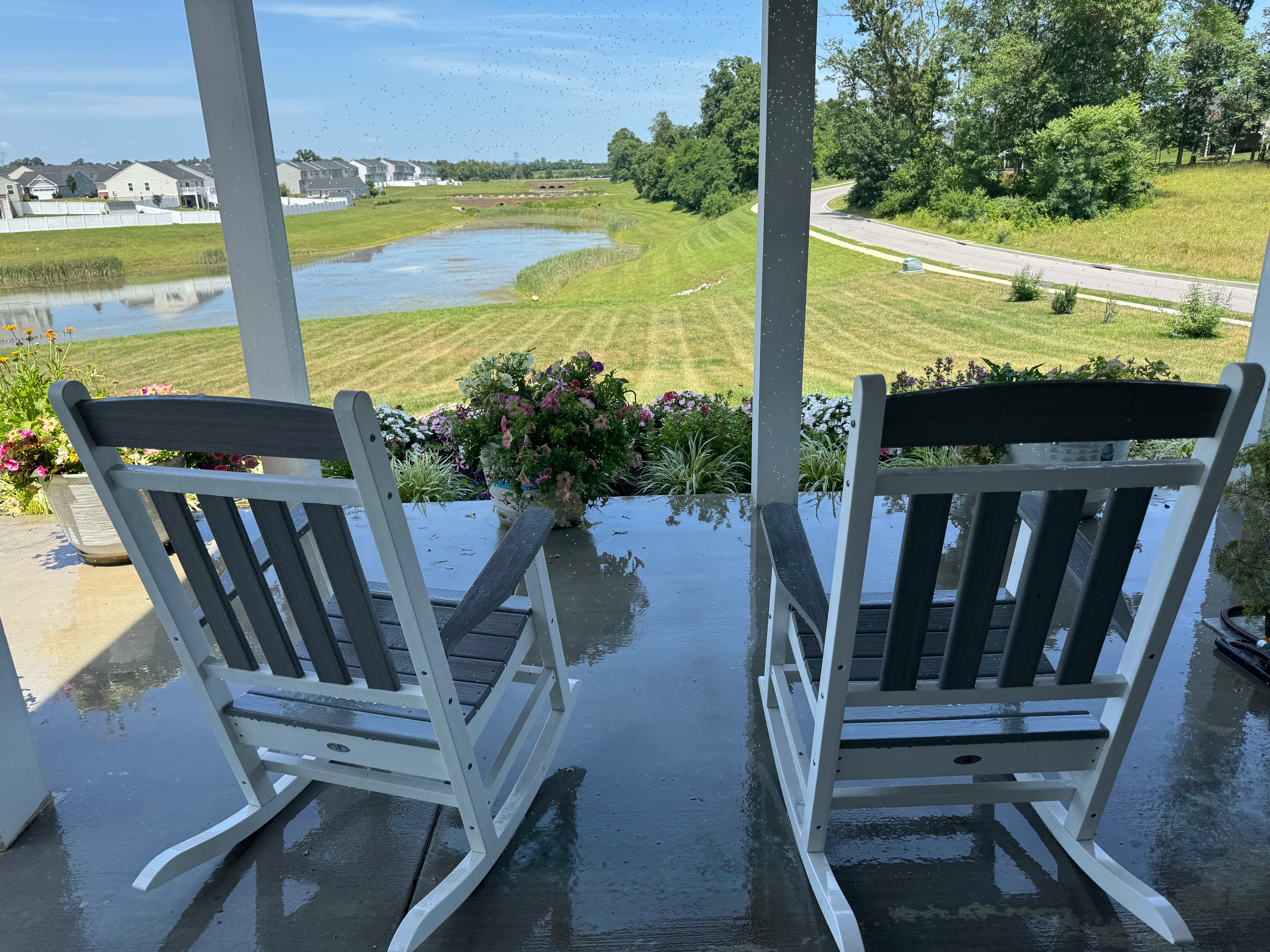 Peaceful porch with rocking chairs overlooking a pond — the Mountain Retreat setting